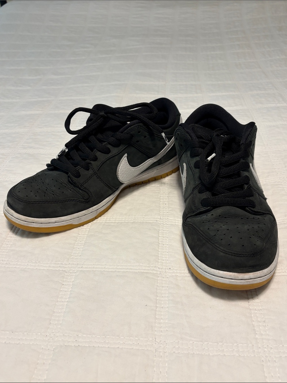 Nike Black Low-Top Sneakers with White Swoosh and Gum Sole